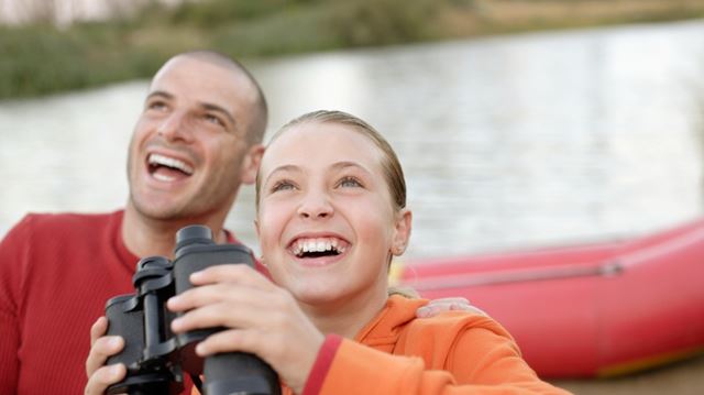 Father and child with binoculars